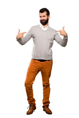 Handsome man proud and self-satisfied over isolated white background