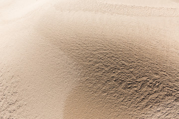 Texture of yellow sand on the coast. Background, textured