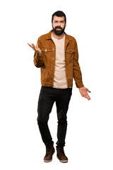 Handsome man with beard making doubts gesture over isolated white background