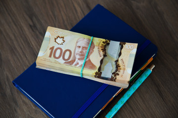 Canadian currency and flag, household budget planning, Canadian economy