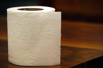 Toilet paper on wooden background
