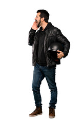 Full-length shot of Biker man shouting with mouth wide open to the lateral over isolated white background