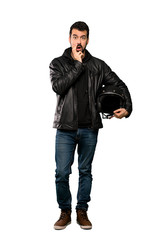 Naklejka premium Full-length shot of Biker man surprised and shocked while looking right over isolated white background