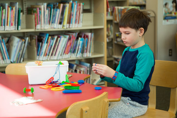 Caucasian boy playing in a Canadian library
