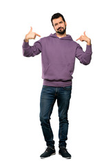 Full-length shot of Handsome man with sweatshirt proud and self-satisfied over isolated white background