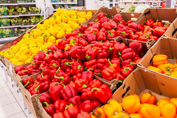 Multicolored bell peppers on the counter in the supermarket