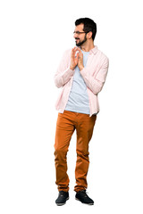 Full-length shot of Handsome man with beard scheming something over isolated white background