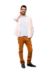 Naklejka premium Full-length shot of Handsome man with beard smiling over isolated white background