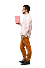 Handsome man with beard eating popcorns