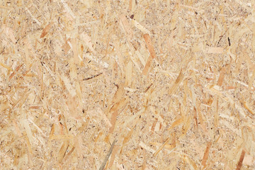 Background of textured wood chipboard , natural color.