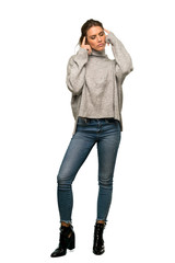 A full-length shot of a Blonde woman with turtleneck having doubts and thinking over isolated white background