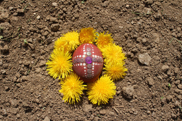 Burying the Old Easter egg in the first furrow of the earth. Old Slavic pagan fertility ceremony