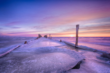 Winter seascape of wood breakwaters on frozen Baltic sea
