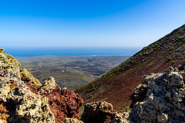 Spain, Lanzarote, Endless volcanic countryside behind volcanic lava rocks on top of volcano corona