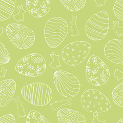 Beautiful green seamless background with Easter eggs and rabbit.