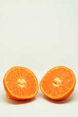 Peeled orange and mandarin slices on white isolated background