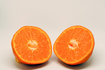 Peeled orange and mandarin slices on white isolated background
