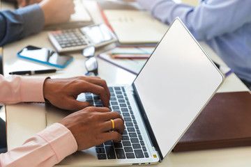 Businessman working on laptop in a meeting at office. Business team meeting and discussing project plan.