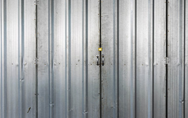  Texture of a metal  iron door  with a padlock locked