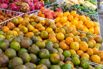 Naklejka na ściany i meble Many kinds of fresh fruits sold in Hatyai fruit market, Songkhla, Thailand.