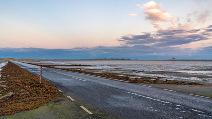 Evening sky and low tide on the road  between Beal and Holy Island, Northumberland, England, UK