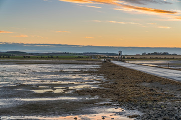 Evening sky and low tide on the road  between Beal and Holy Island, Northumberland, England, UK