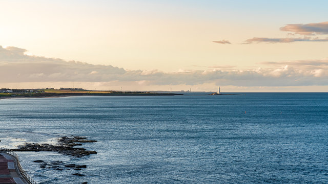 View from the Whitley Sands beach in Whitley Bay, Tyne And Wear, England, UK - looking north towards St. Mary's Lighthouse