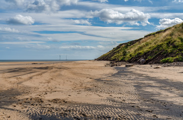 Fototapeta na wymiar North Sea coast in Cambois, Northumberland, England, UK - the beach with wind turbines in the background
