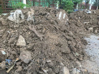 pile of dirt near the wall for construction