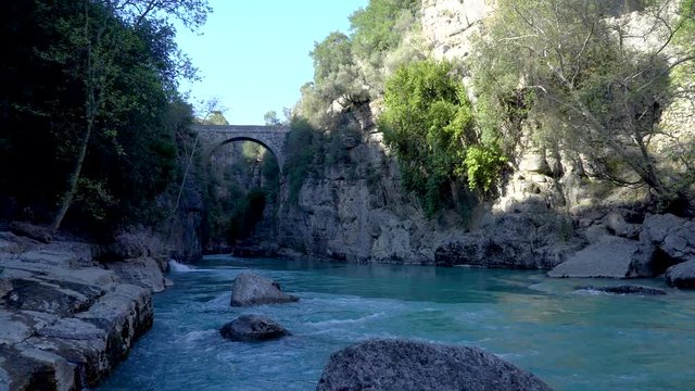 Antalya, Turkey - March 2019: Antique Oluk Bridge across Kopru Irmagi creek in Koprulu Kanyon national park in Antalya Turkey.