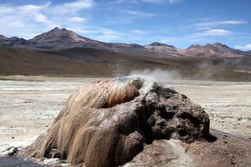 El Tatio geysers in Atacama desert, Chile: Geyser cone spitting hot water