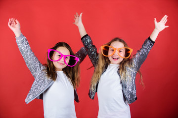 Celebrating together. Party girls. Cool party girls wearing fancy glasses. Small kids in party...