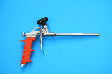 mounting foam sprayer gun pistol tool on blue background
