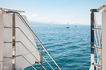 Modern boat open deck railing with view of Lake Leman (Geneva Lake) on beautiful sunny summer day