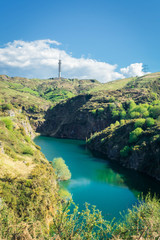 blue lake on the mountain with an antenna on top, la arboleda, basque country