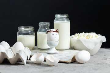 Fresh dairy and fermented milk products. Eggs On a black background.