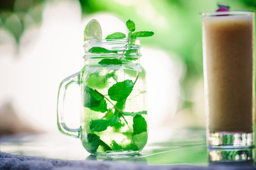 Mojito cocktail served on glass at outdoors, refreshing cuban cocktail