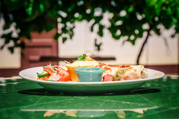 typical mexican breakfast, burrito or taco served on plate