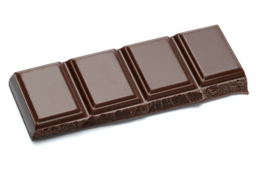 Dark organic chocolate pieces isolated on white background