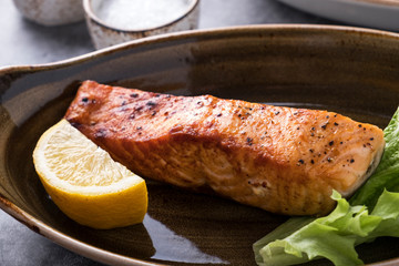 Grilled salmon served with lemon.