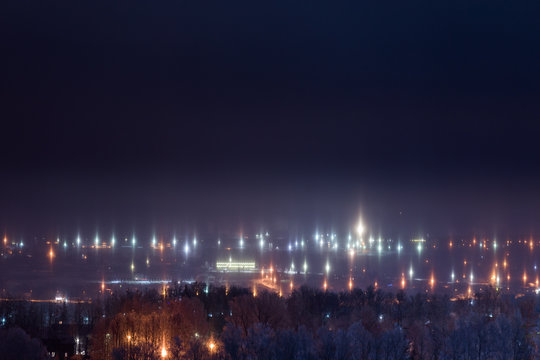 Night Winter Cityscape With Light Pillars Atmospheric Phenomenon