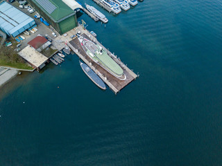 Aerial view of passenger ship in shipyard on land for maintenance.