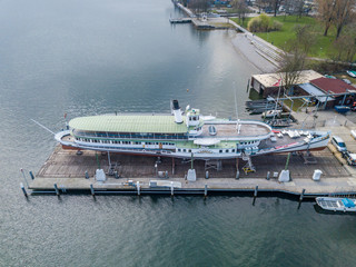 Aerial view of passenger ship in shipyard on land for maintenance.