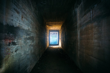 Light in end of old grungy concrete tunnel or tube or corridor, abstract way to hope concept in...