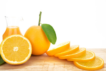 Orange juice and oranges with leaves
