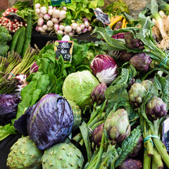 Fototapeta na wymiar Arrangement of green, purple and red vegetables on market table
