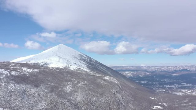 Pyramid shaped peak of mountain Rtanj under snow 4K aerial video