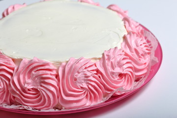 Cooking cake, decorated with a cream of different colors.