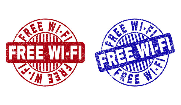 Grunge FREE WI-FI round stamp seals isolated on a white background. Round seals with grunge texture in red and blue colors. Vector rubber imitation of FREE WI-FI text inside circle form with stripes.