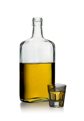 Incomplete bottle of whiskey rectangular shape without lid and filled glass, isolated on a white...